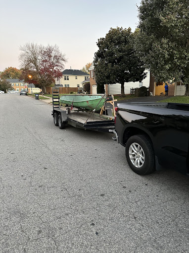 A truck pulling a boat on the back of it's trailer