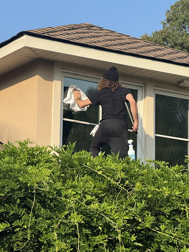 A man cleaning a window in a house